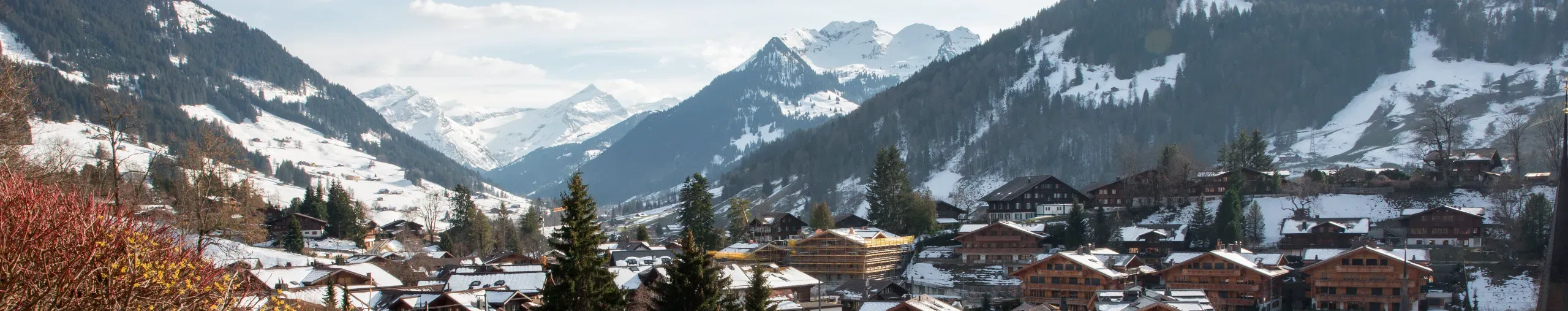 Snowy rooftops and mountains in Gstaad. 